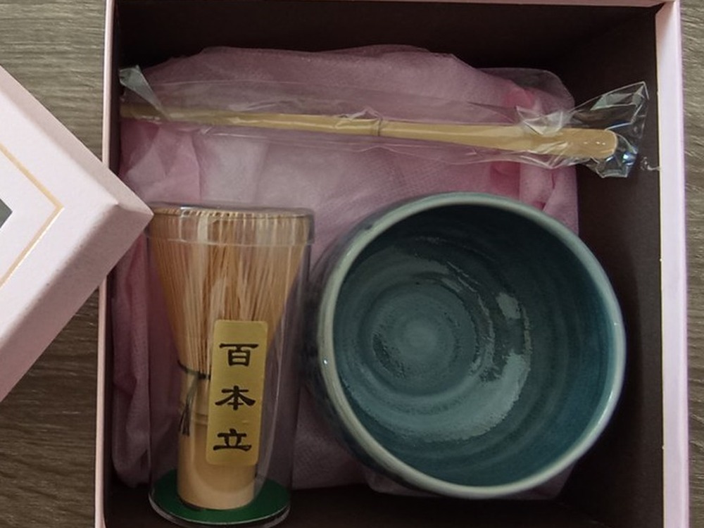 Matcha gift set — the open presentation box with a 100-prong bamboo whisk, bamboo scoop and a matcha bowl