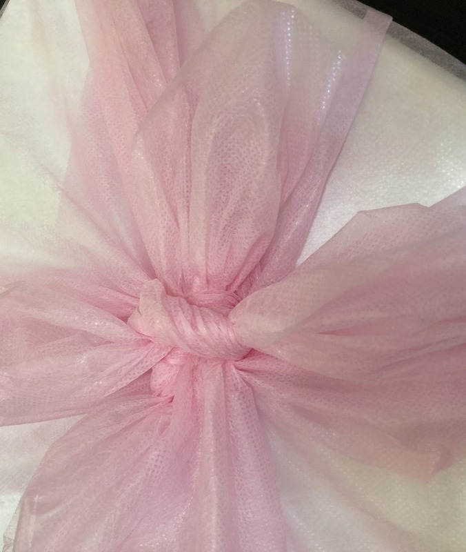 Gift Cheesecake — wrapped in pink organza with a ribbon